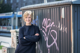 Stefanie Schardien vor einem Bauwagen mit Graffiti